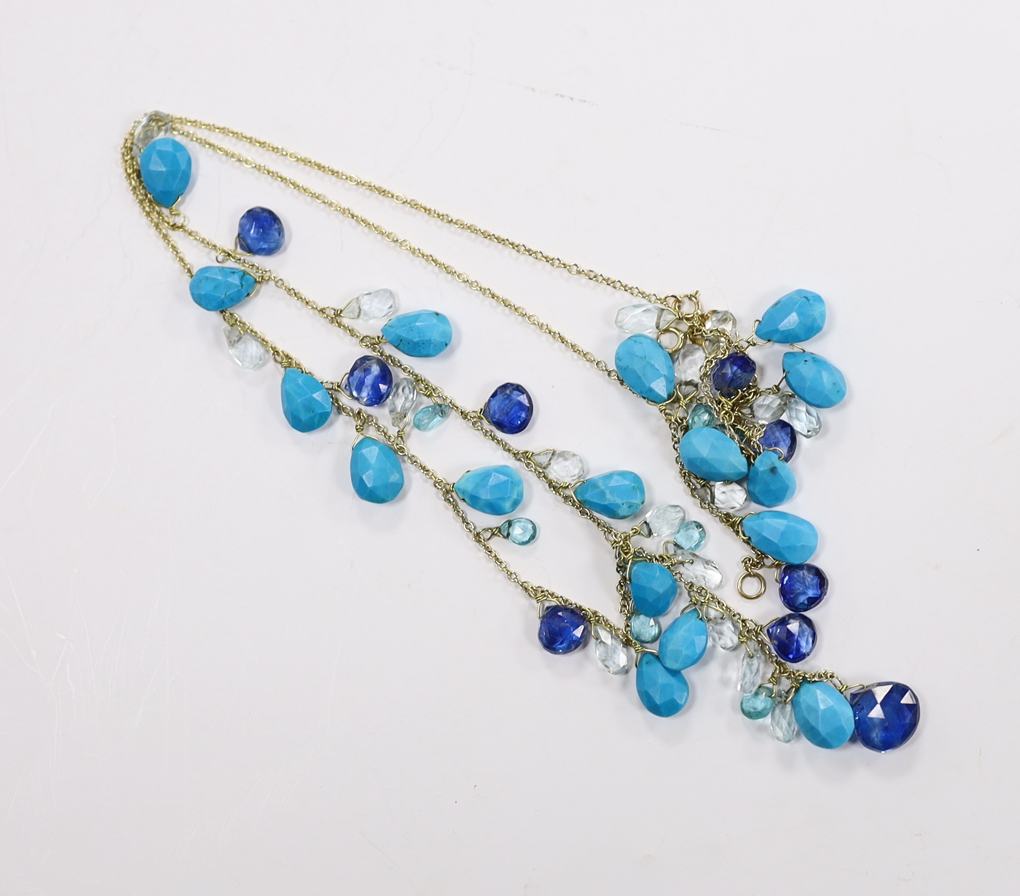 A modern 18ct gold and multi facet cut gem set fringe necklace, 56cm and matching bracelet, gross weight 21 grams